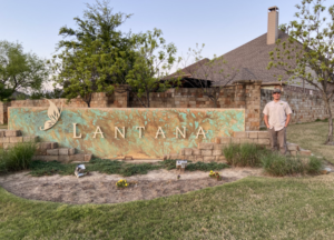 Lantana sign with a smiling AAAC Wildlife Removal specialist